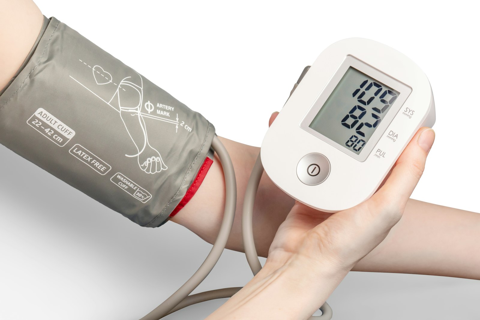 A person checking their blood pressure with a digital monitor